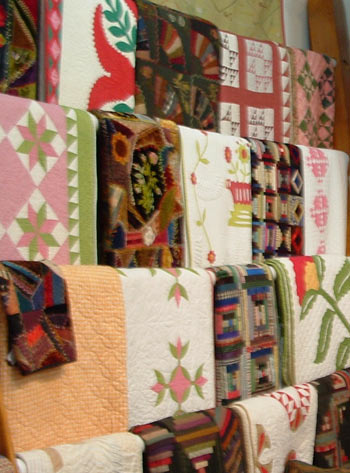 Picture of quilts on racks in the interior of Rocky Mountain Quilts.